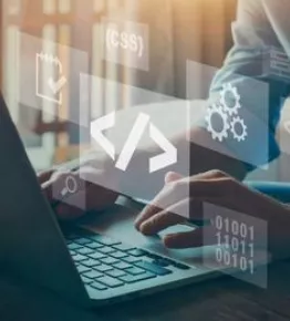 a person typing on a computer, low-code icon is presented